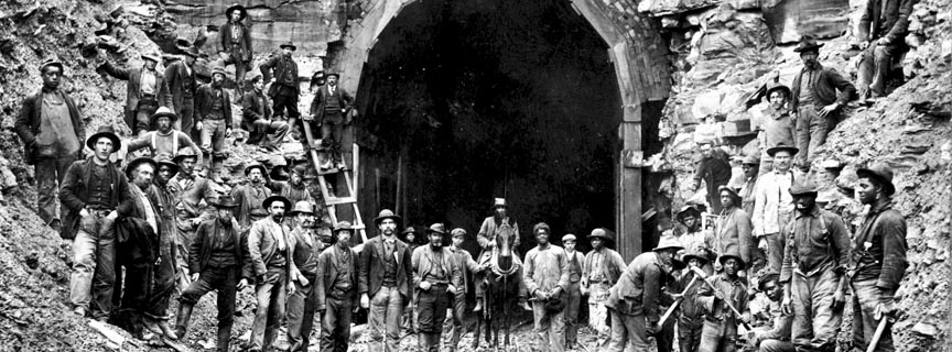 workers posing in front of a RR tunnel