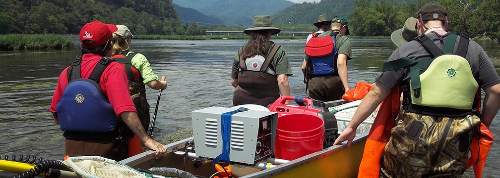 researchers with canoe