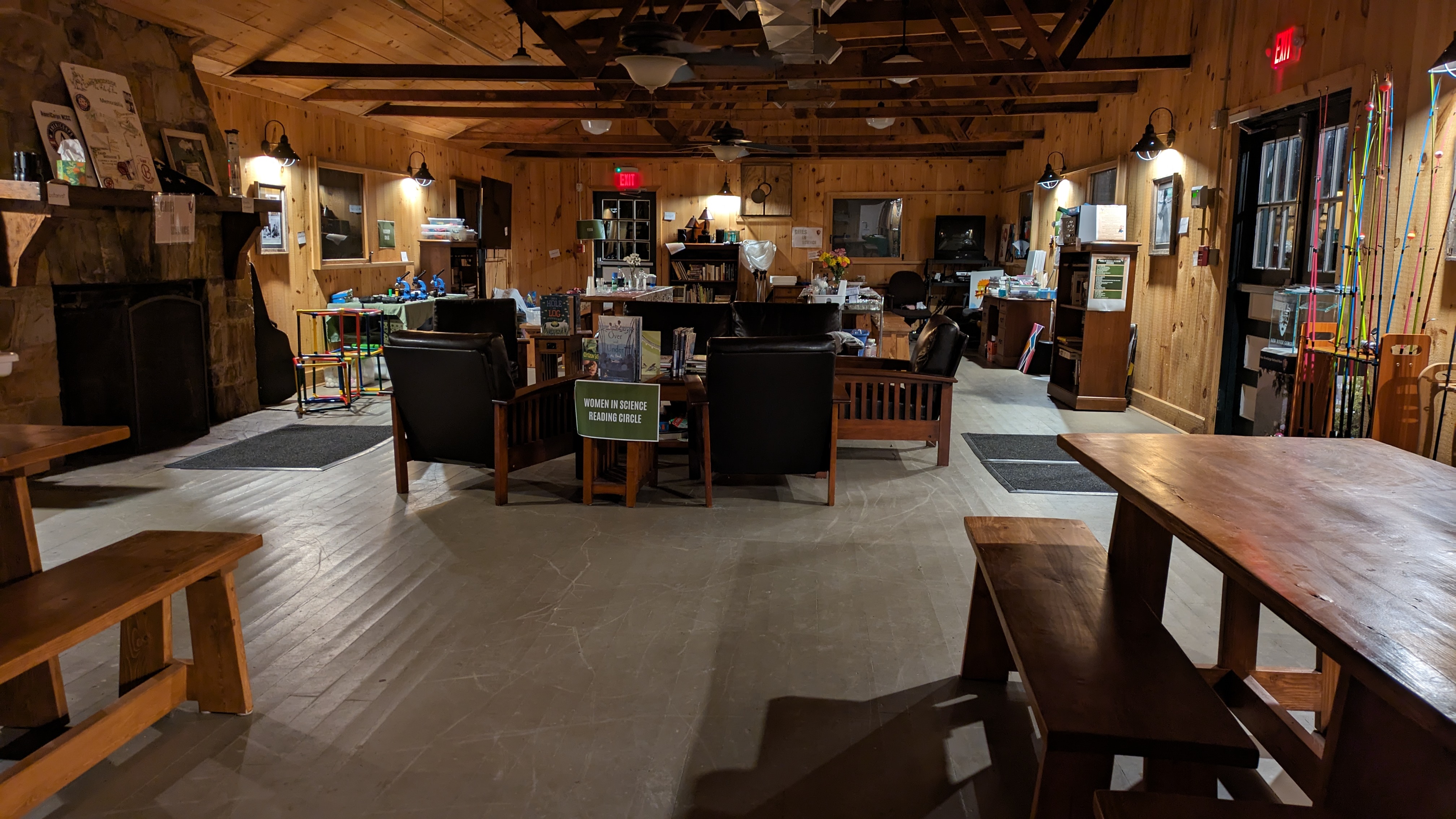 Dimly lit mess hall with education stations around room