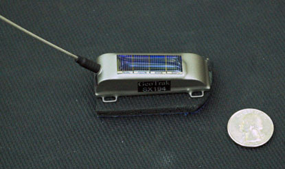 Satellite transmitter beside U. S. quarter (for scale)