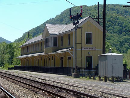 Historic train depot of Thurmond behind railroad tracks