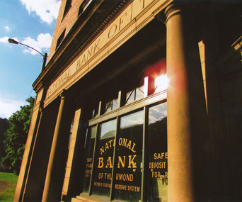 sun beam reflects off bank window