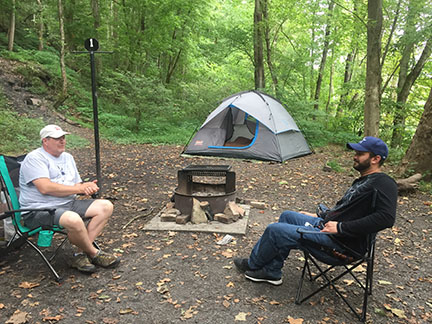 two campers in front of a tent