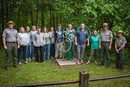 Friends_AHDed (1) people posing by a bike repair station at a trailhead