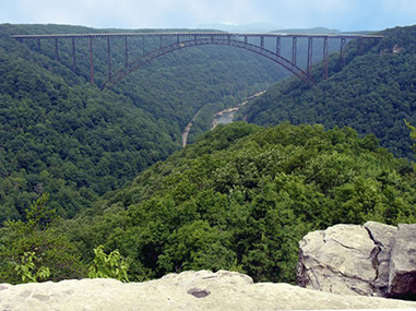 bridge spanning over a river and deep gorge