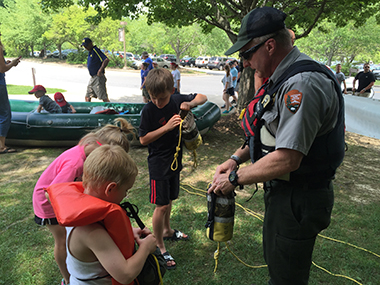 ranger teaching kids to use a throw bag