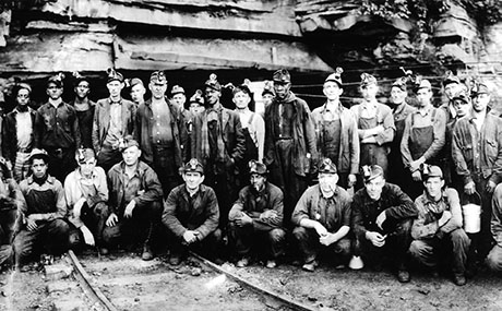 coal miners pose in front of mine