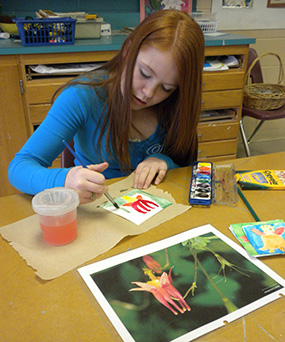 Girl painting a wildflower