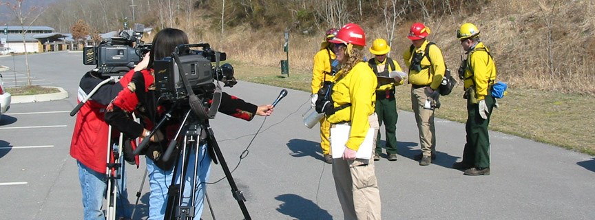 reporter conducting an interview with a firefighter reporter conducting an interview with a firefighter