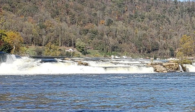 Waterfall falling over rocks across the Kanawha River