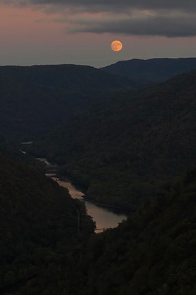 moon over a deep river gorge