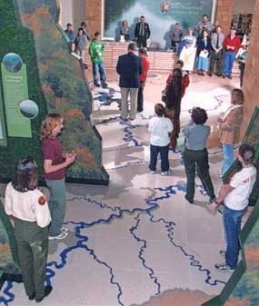 Visitors and watershed floor map inside Sandstone Visitor Center