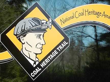 A graphic image of a coal miner with a helmet and light.