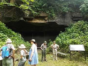 hikers and ranger at coal mine opening