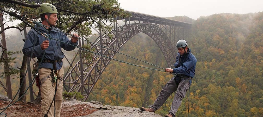 Rappeller descending into the gorge