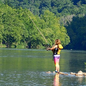 girl fishing in river