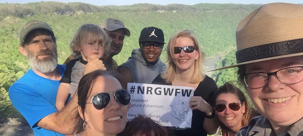 ranger at an overlook with visitors