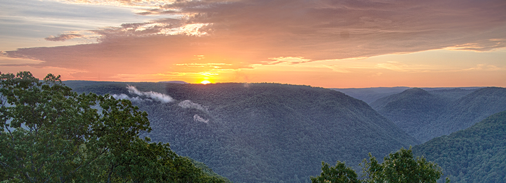 Sun setting over a deep river gorge