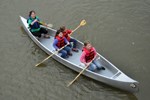 A volunteer helps three girls paddle a canoe down the Niobrara NSR. A volunteer helps three girls paddle a canoe down the Niobrara NSR.
