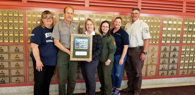 Group of people accepting a plaque