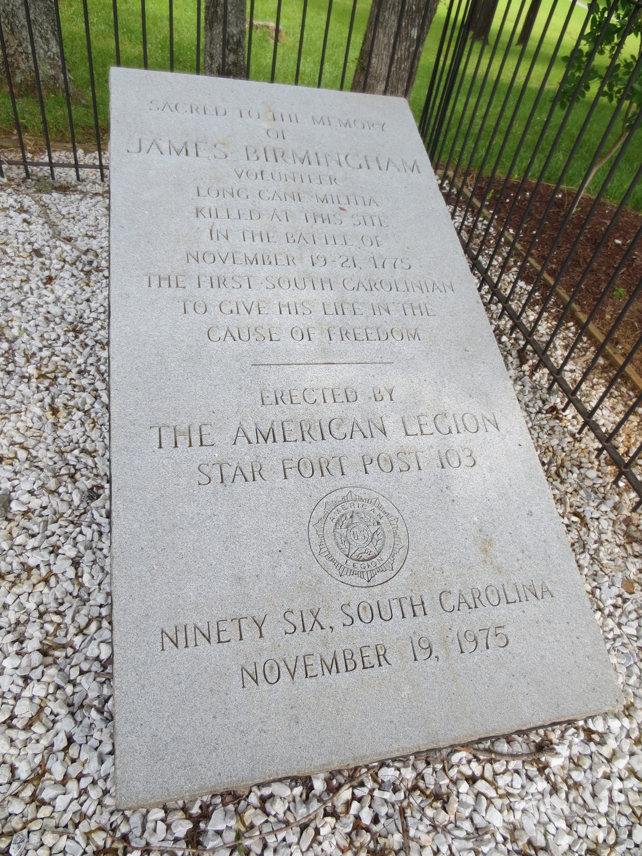 Gray stone monument to James Birmingham.