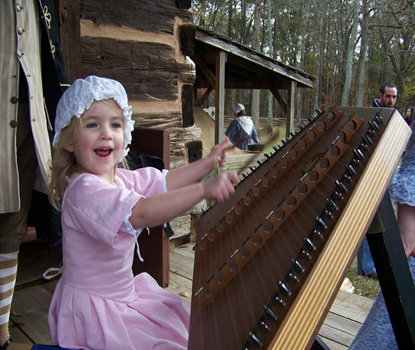 Girl playing hammer dulcimer