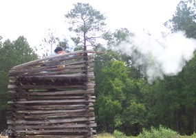 Patriot reenactor firing musket from Maham Tower, May 2006