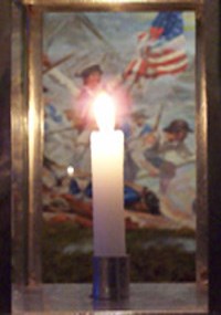 Lit candle infront of historic battle painting