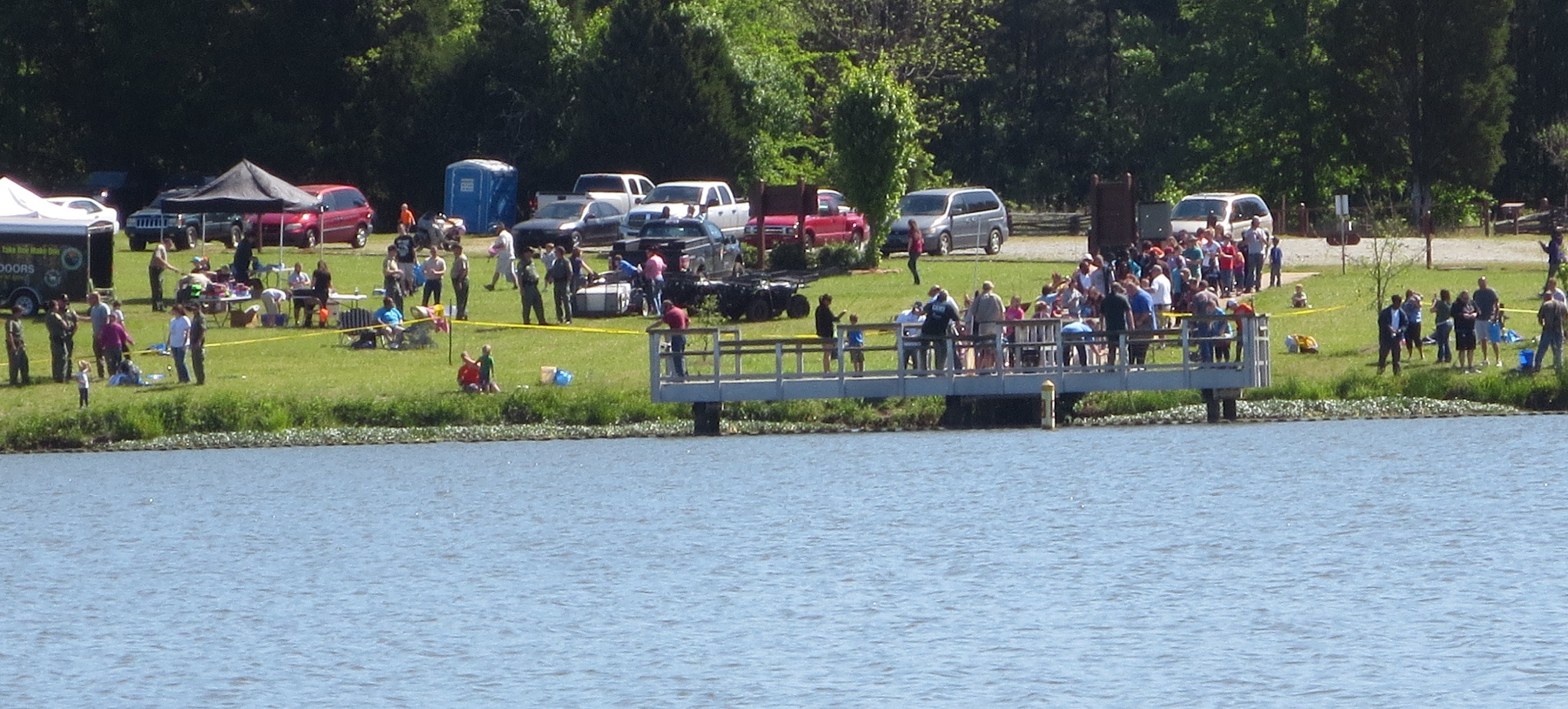 Crowds gather at the pond to fish.