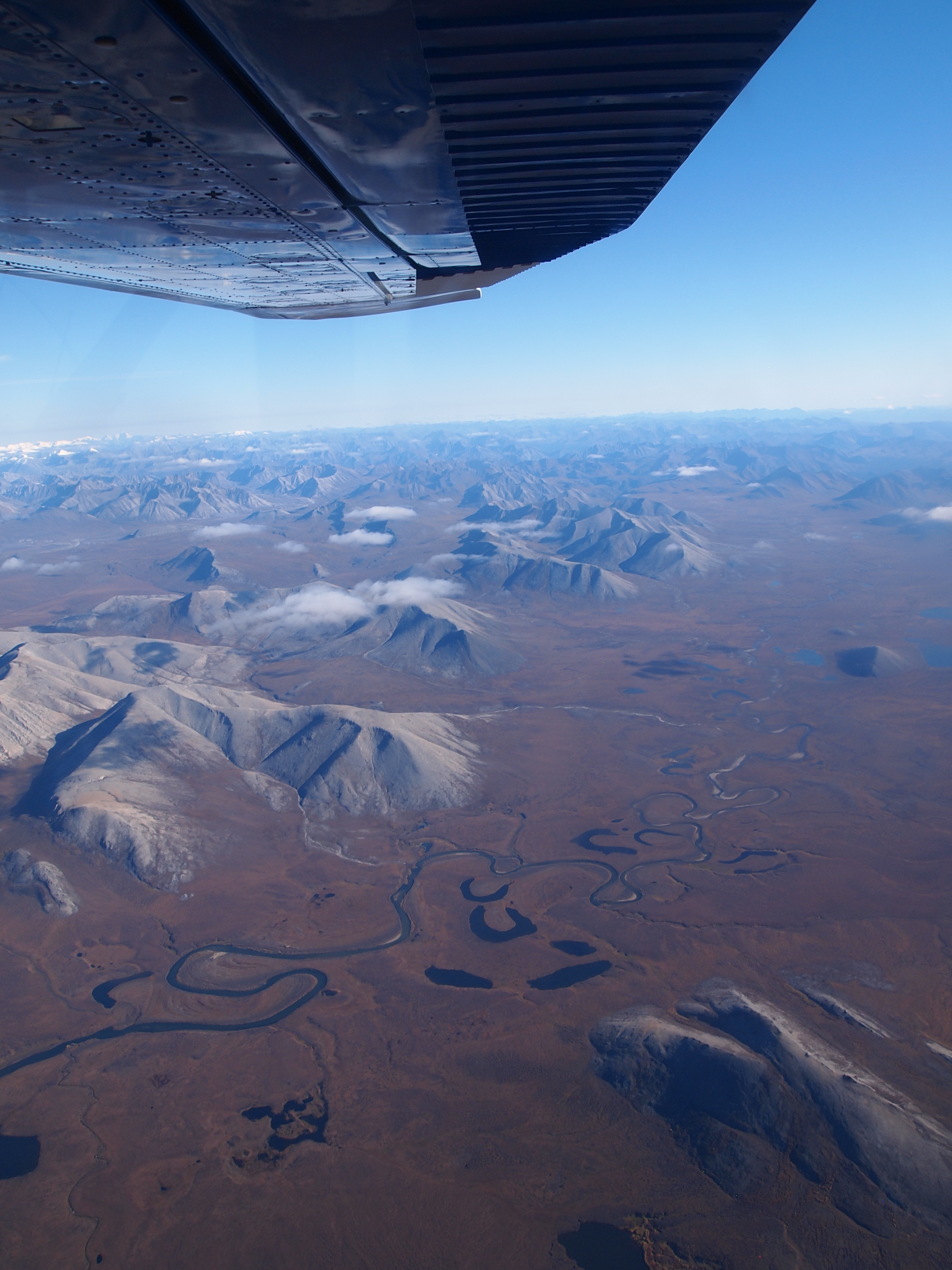 Mountains and tundra with river winding through it