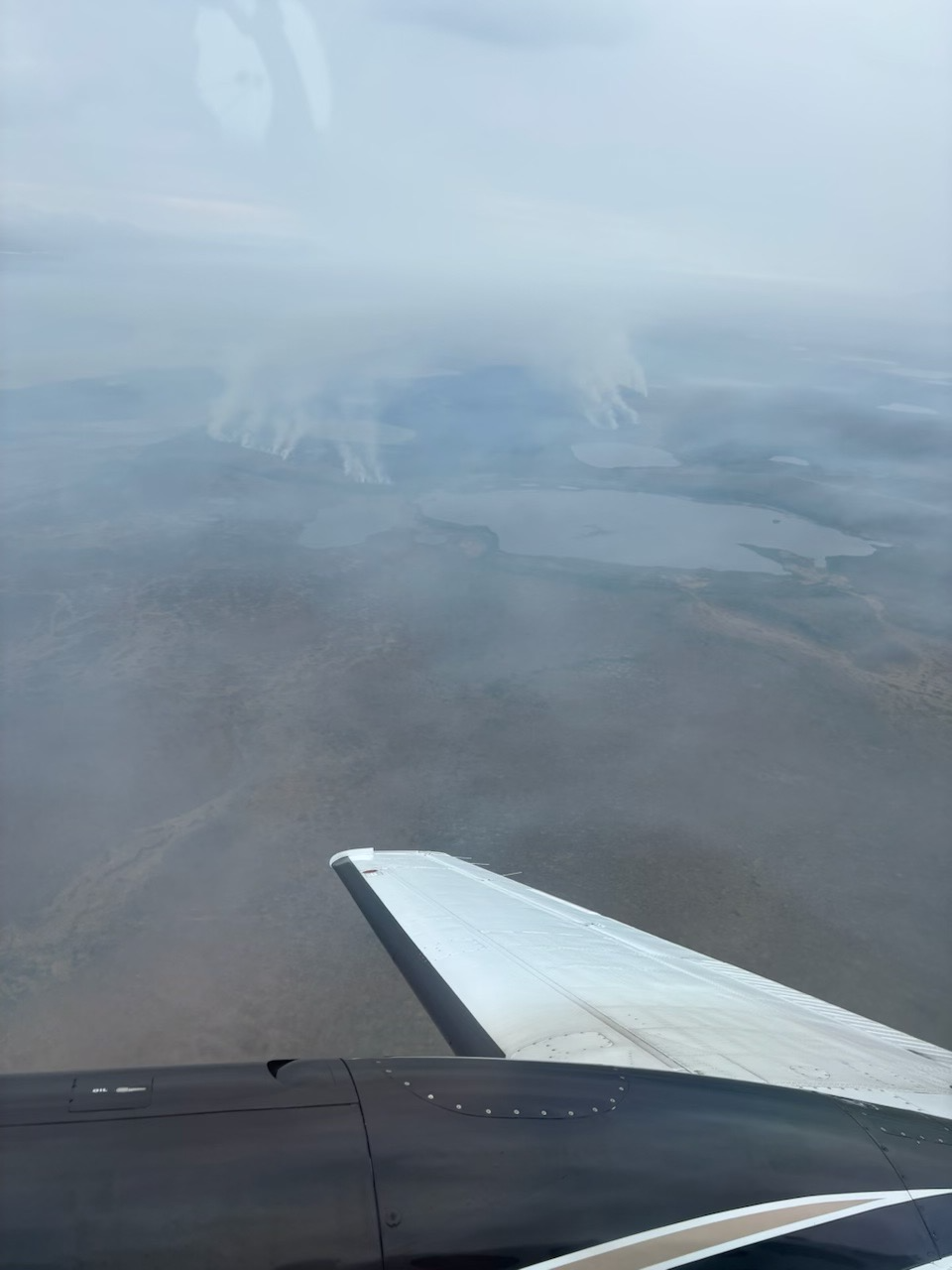Noatak Fires - June 13, 2024 Hazy image from wildfire smoke. Smoke rising from the tundra below a spotter airplane.