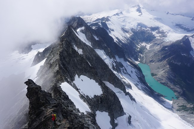 A NOCA ranger descending the West Ridge of Forbidden Peak