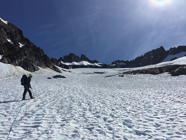 A ranger ascends the Quien Sabe Glacier towards Shark Fin Tower