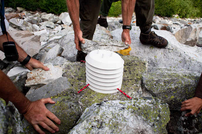 Setting these white shields over data loggers protects them from the weather. NPS/Karlie Roland