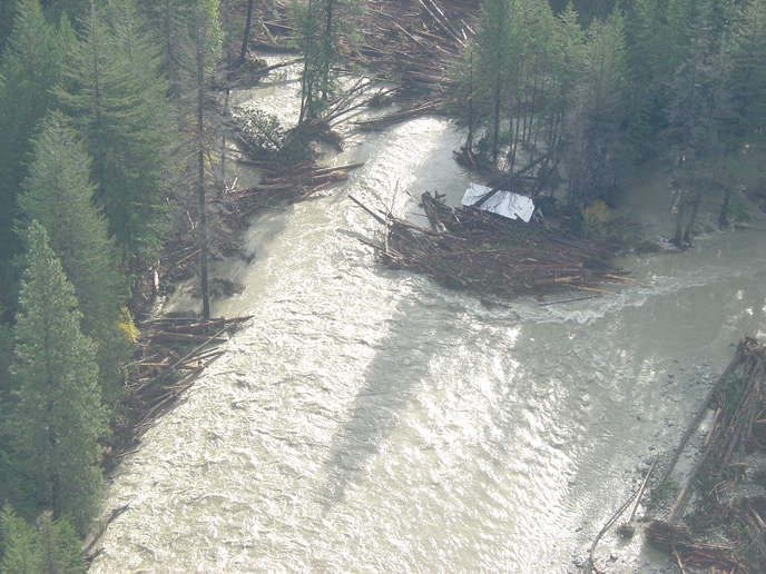 Private cabin, well, and septic system incorporated into logjam at McGregor Meadows during 2003 flood. Image Credit: NPS/NOCA