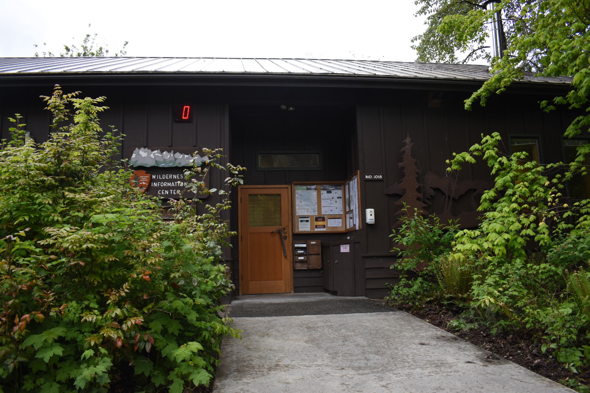 Wilderness Information Center Entrance brown building with sign that reads "Wilderness Information Center