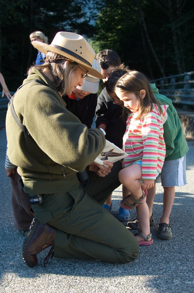 A ranger leads a birding walk