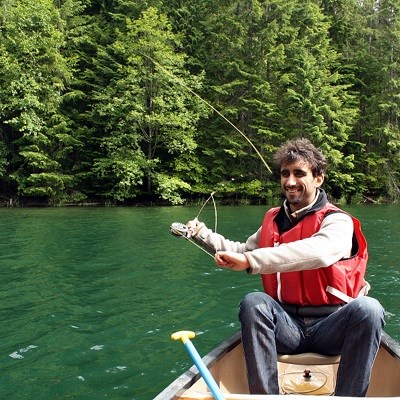 An angler fishing from a canoe.