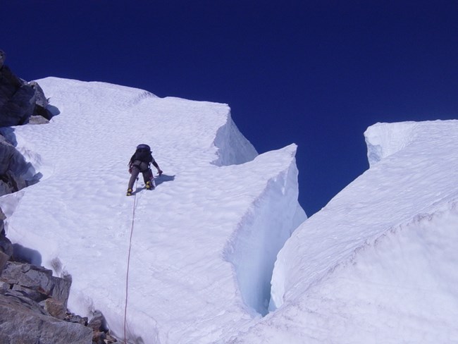 Climber passing crevasses on Challenger Peak