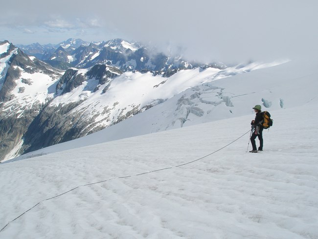 Climber on Inspiration Glacier as clouds move in.