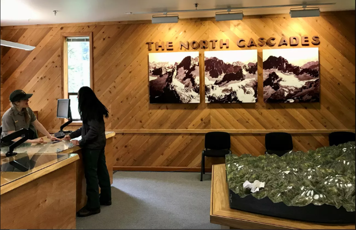 A ranger talks to a visitor at an information center.