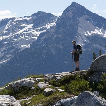 Hiker standing at a mountain overlook.