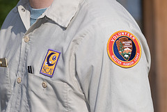 A volunteer proudly displays teh Volunteer patch, often synonomous with the Student Conservation, as shown