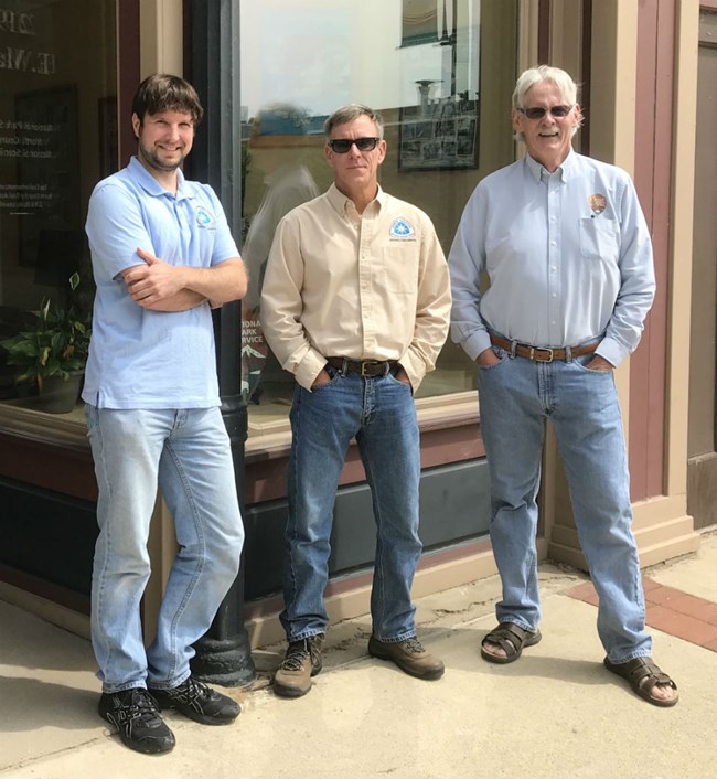 Three North County Trail staff in front of office.