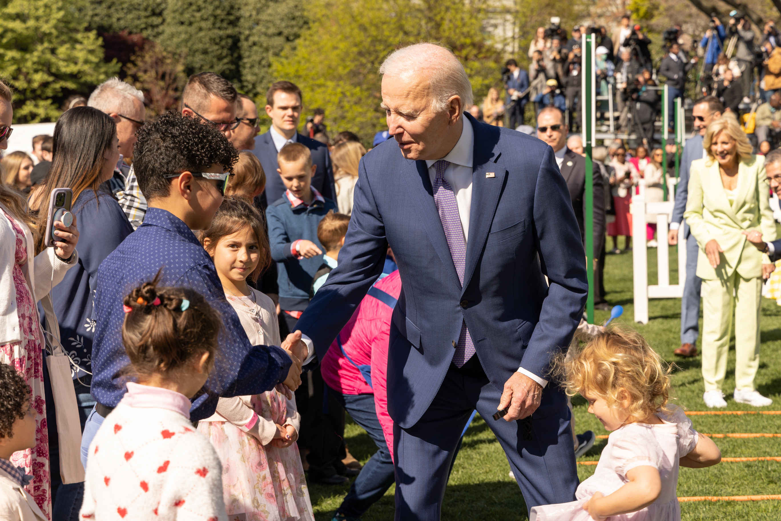 President Joe Biden shakes hands with children  at the White House Easter Egg Roll