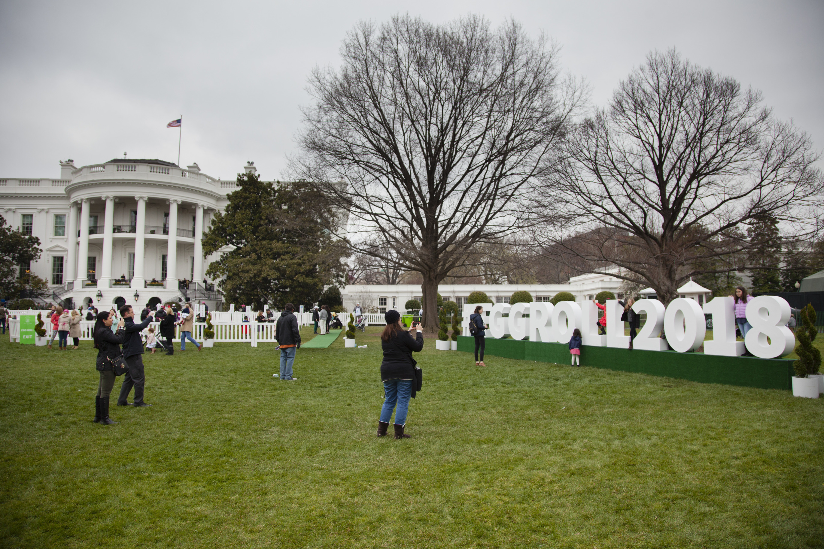 Children pose on a photo prop for the 2018 Easter Egg Roll on the south lawn of the White House. 