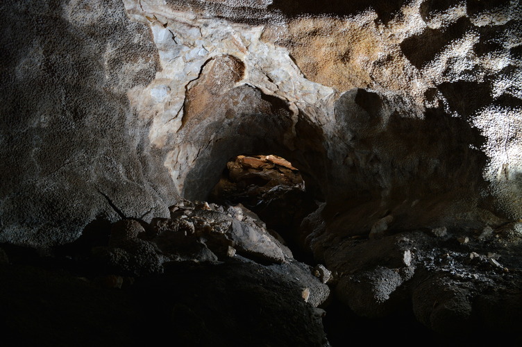 Bumpy crystal walls in a dark cave room