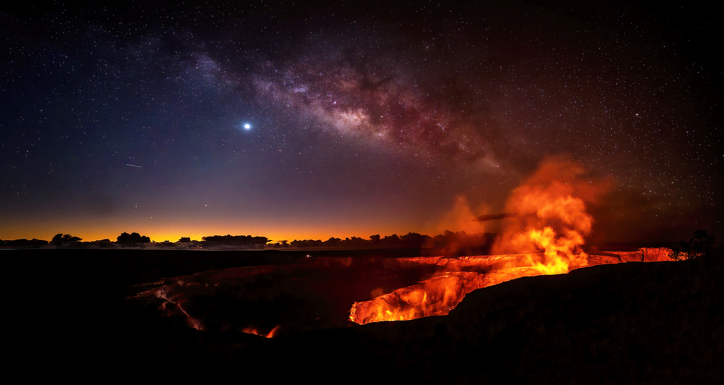 The Milky Way arching over the Kilauea caldera at night in Hawaii Volcanoes National Park