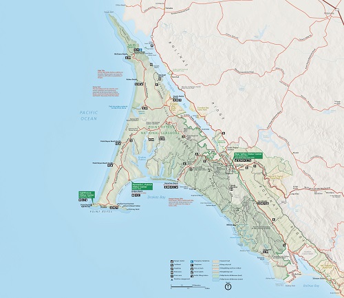 Map of Point Reyes National Seashore in California. The map shows a tapering green peninsula jutting into the blue Pacific Ocean off of a tan land mass.