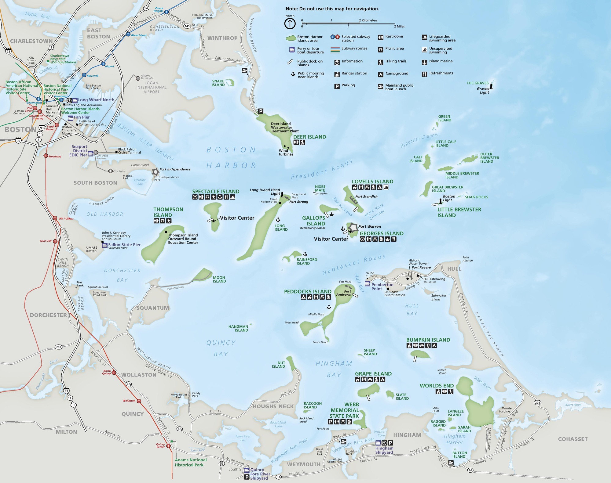 Park map of Boston Harbor Islands National Recreation Area, showing the bays, inlets, islands, and landmarks in and around Boston Harbor. Indicated in brown, the harbor curves like a C from the top left corner to the bottom right of the map. Two dozen islands scattered throughout the harbor are green and the water is blue. 